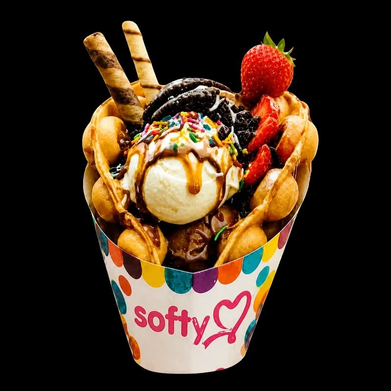 Cône bubble waffle garni de glace, fraise, Oreo, caramel et crunchy